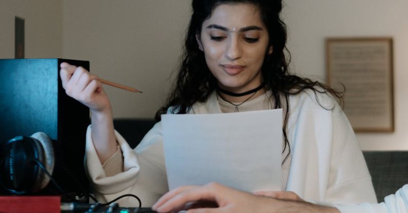 Home Recording Studio - A Woman in White Coat Sitting at the Table