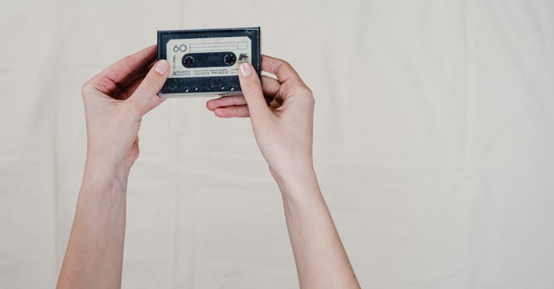 Audio Format - Person Holding Black and Gray Cassette Tape