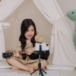 Recording Acoustic Instruments - A Cute Girl Recording a Video while Playing Ukulele