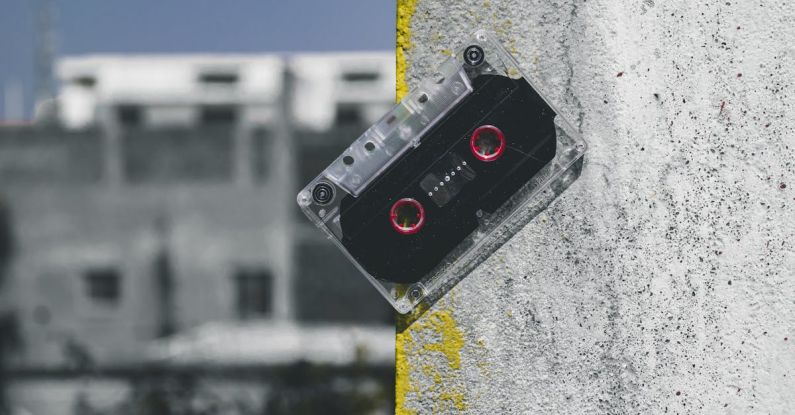 Multi-Track Recording - Clear and Black Cassette Tape on Gray Surface