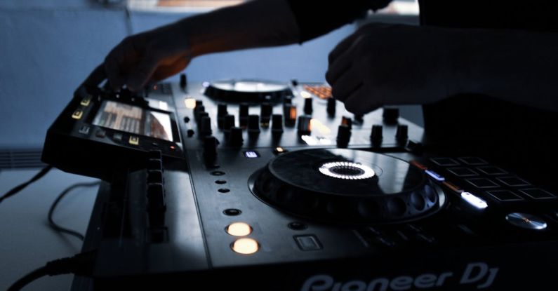 DJing - Person Playing Black and White Dj Controller