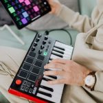 MIDI Controllers - Hands of a Man Using a MIDI Controller