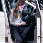 Sound Engineer - Female Engineer Sitting on a Car