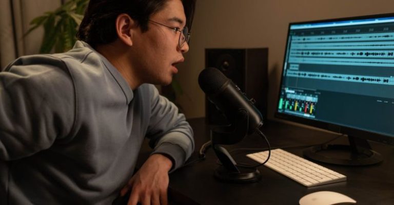 Sound Engineer - A Man in Gray Sweater Sitting at the Table