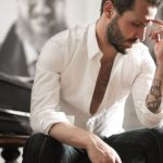 Sound Balancing - Dramatic tattooed male sitting at piano