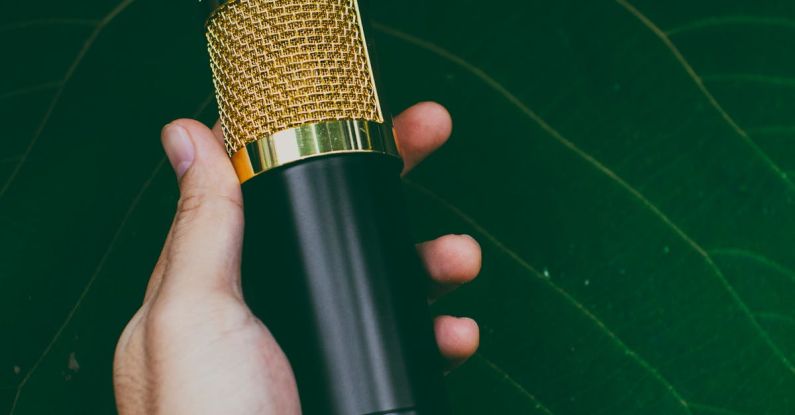 Sound Quality - Crop anonymous person showing modern recorder in hand against green leaf of plant in daylight