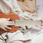 Room Acoustics - A Girl Holding Brown Ukulele