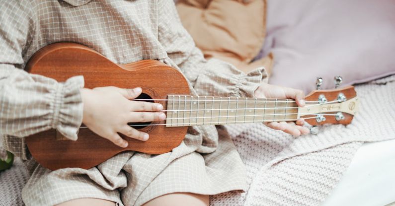 Room Acoustics - A Girl Holding Brown Ukulele