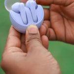 Surround Sound - A person holding a small blue object in their hand