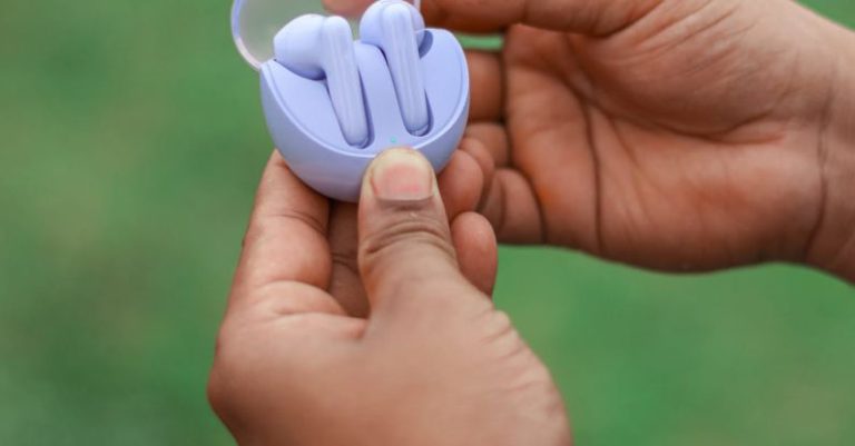 Surround Sound - A person holding a small blue object in their hand