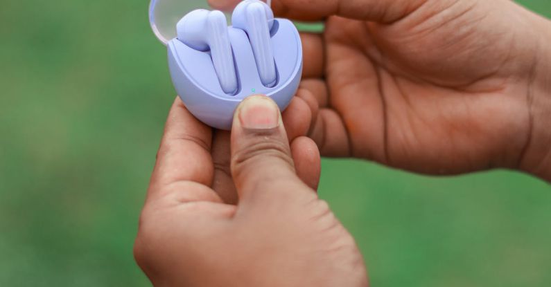 Surround Sound - A person holding a small blue object in their hand