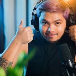 Studio Headphones - A man with purple hair giving the thumbs up