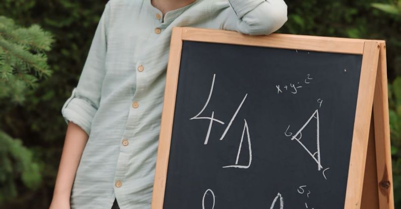 Smart Speakers - A boy standing next to a chalkboard with the word surf