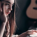 Streaming Services - Photo of Woman Lying on Bed While Using Laptop