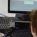 Software Updates - Unrecognizable sound engineer installing software on desktop computer at home