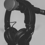 Audio - Black Headset Hanging on Black and Gray Microphone