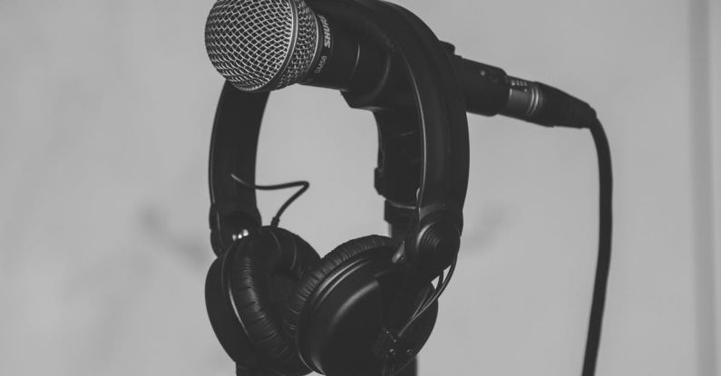 Audio - Black Headset Hanging on Black and Gray Microphone