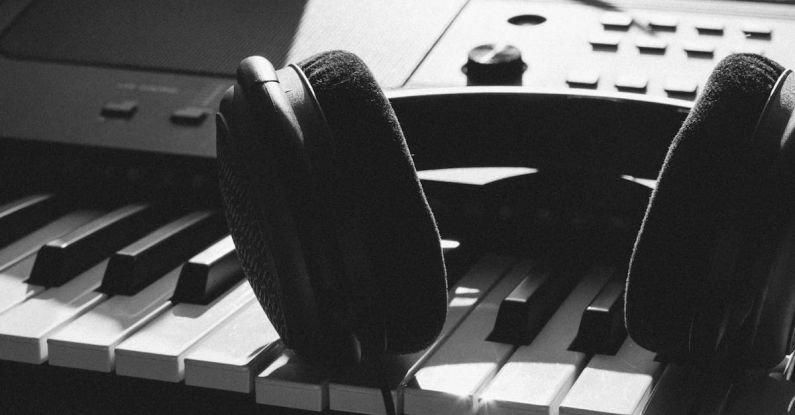 Music Production - Black Wireless Headphones on Gray Electronic Keyboard