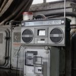 Music Production Setup - Old fashioned cassette player placed in shabby garage near old industrial equipment