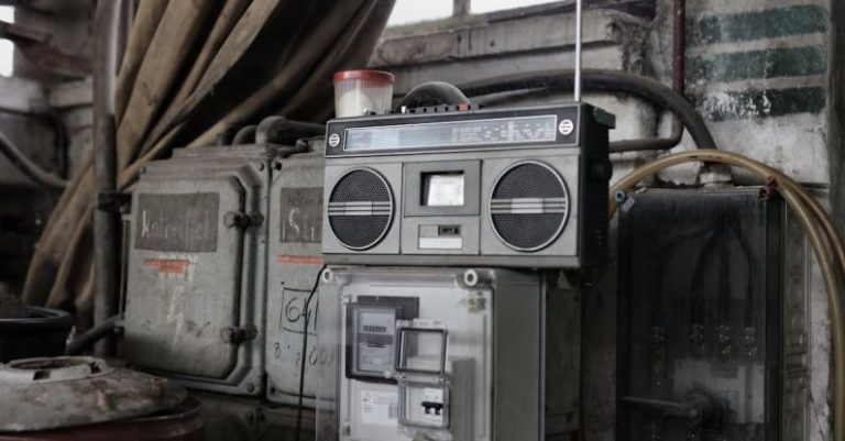 Music Production Setup - Old fashioned cassette player placed in shabby garage near old industrial equipment