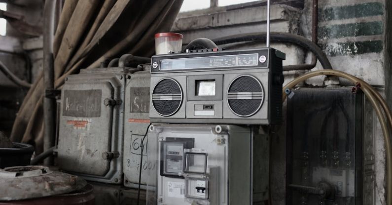 Music Production Setup - Old fashioned cassette player placed in shabby garage near old industrial equipment
