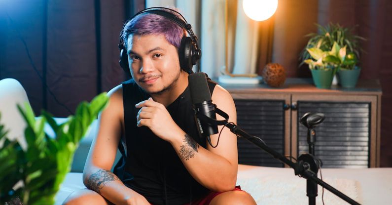 Podcast Editing - A man with purple hair sitting in front of a microphone