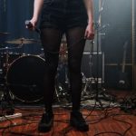 Microphone - Woman in Black Denim Shorts Standing on Brown Wooden Floor