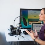 Podcasting - Woman Wearing Purple Dress Sitting on Chair Near Window
