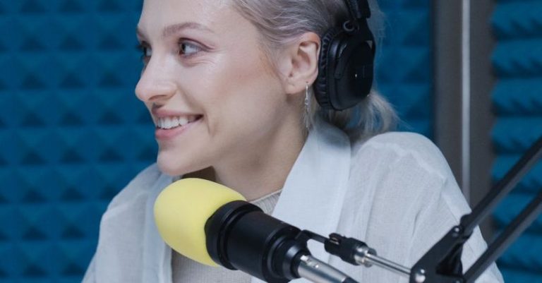 Podcasting - Woman in White Long Sleeve Shirt Wearing Black Headphones